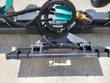 Soil conditioner from above: green hydraulic manifold, coiled hoses and the angle-control switch on the frame