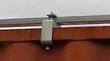 Galvanized steel mounting bracket clamping the shelter frame to the top rail of a shipping container