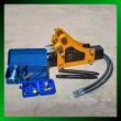 Yellow hydraulic breaker with mount bracket, two chisels, tool box, nitrogen kit and hydraulic hose
