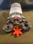 Hydraulic gear pump with splined shaft, shown with two jaw coupler hubs and orange spider insert