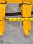 Tape measure between two of the bucket's PC-60 teeth, spanning about four inches