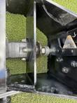 Sickle bar mower drive: hydraulic motor and pulley shaft beside a triangular serrated cutter blade