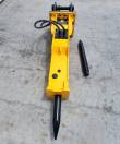 TOFT750 breaker viewed down its length, moil chisel fitted and a spare chisel lying alongside