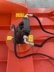 Topcat brush cutter orange motor housing with black hoses and yellow warning labels