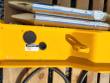 GREASING decal, grease fitting and lifting eye on the SDCH680's yellow body, two wrapped chisels above