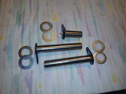 Hardened steel attachment plate pins with black flag plates, grease fitting and six shim washers