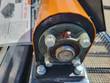 End of the vibration motor housing, showing the drive shaft bearing flange and its mounting bolts.