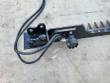 Sickle mower's pin-on mounting bracket and hydraulic drive motor, hoses looped out, cutter bar to the right