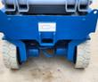 Genie GS-3232 rear drive axle with hydraulic drive motors, solid tires and the scissor stack stowed above