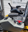SDLE20 mini excavator console: pilot joystick and armrest, red shutoff knob, keyed ignition and work-light switch