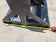Tape measure across the forklift jib's black steel base, reading about 28 inches