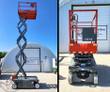 Red Skyjack SJIII 3219 scissor lift raised to full height on its scissor stack, and the same unit lowered head-on