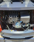 MX15RX open engine bay: gasoline engine with caged muffler, air filter box and fuel lines