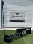 Wolverine sickle bar mower on its quick-attach plate, cutter bar raised upright, hoses and hydraulic valve