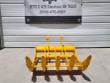 Yellow TOFT08R rake standing upright, five tine tips forward over a serrated bar, twin pin-boss arms