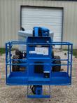 Genie boom lift rear turret close-up, folded boom base and drive wheels