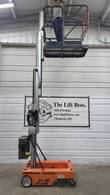 JLG 12SP vertical mast lift with the platform raised and a person standing on it, side view