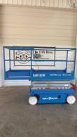 Blue Skyjack SJIII 3219 electric scissor lift, stowed, side view with platform extension out