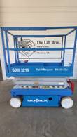 Blue Skyjack SJIII 3219 scissor lift, stowed, side view with Skyjack decal and red entry step