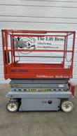 Skyjack SJIII 3219 scissor lift lowered, opposite side view with Keep Clear scissor guard and platform controls