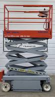 Skyjack SJIII 3219 scissor lift raised part way, side view showing the scissor stack and lift cylinder