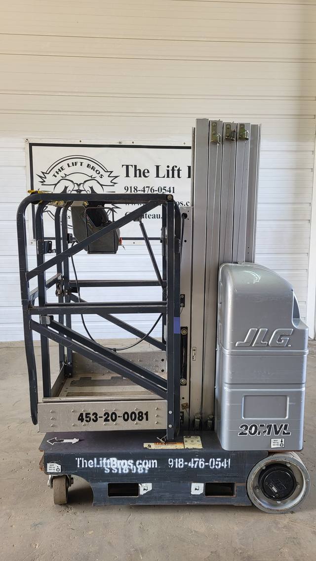 Gray JLG 20MVL vertical mast lift, stowed, side view with platform, mast and drive wheel