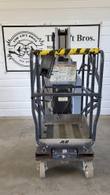 JLG 20MVL mast lift platform end, stowed: guardrails with taped top rail, controls and caster wheels