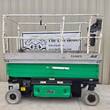JLG 3246ES electric scissor lift, green and silver, stowed, side view with platform rails
