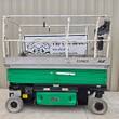 JLG 3246ES electric scissor lift, green and silver, stowed, side view with platform rails