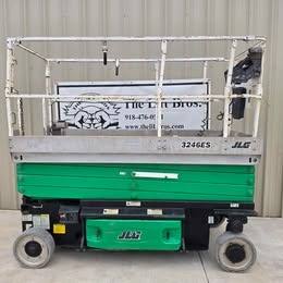 JLG 3246ES electric scissor lift, green and silver, stowed, side view with platform rails