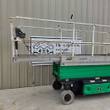 JLG 3246ES scissor lift, silver platform rails and green base, stowed, side view