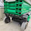 JLG 3246ES green scissor stack, chassis and non-marking wheels up close