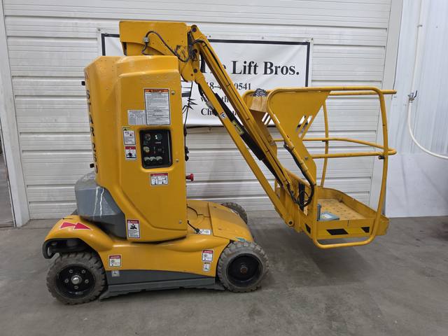 Yellow Haulotte Star 26J mast lift, stowed, side view with jib and caged platform
