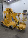 Yellow Haulotte Star 26J mast lift, stowed, 3/4 view with platform, foot switch and ground controls