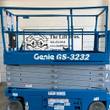 Genie GS-3232 electric scissor lift, blue, stowed, side view with platform rails