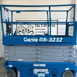 Genie GS-3232 electric scissor lift, blue, stowed, side view with platform rails