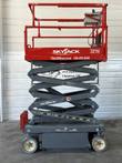 Skyjack 3219 scissor lift raised partway, showing the gray scissor stack under the red platform