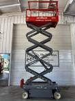 Skyjack 3219 scissor lift raised to full height inside the shop, red platform on the extended scissor stack