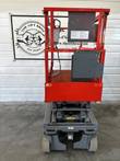 Skyjack 3219 scissor lift stowed, end view of the red platform, guardrails and gray chassis