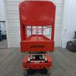 Snorkel S3219E scissor lift end view, orange platform gate and Snorkel decal, stowed