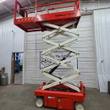 Snorkel S3219E scissor lift raised to full height, white scissor stack under orange platform