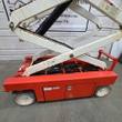 Snorkel S3219E base and lower scissor arms, orange chassis, tray open showing battery cables