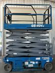 Genie GS-4047 scissor lift raised partway, gray scissor arms under the blue platform
