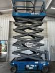 Genie GS-4047 scissor lift raised near full height inside the shop on the extended scissor stack