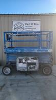 Blue Genie GS3369 RT 4x4 scissor lift stowed, side view showing platform rails, scissor stack and engine tray