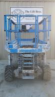 Genie GS3369 RT scissor lift stowed, end view of the platform, scissor stack and entry ladder between the tires