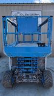 Genie GS3369 RT scissor lift stowed, opposite end view of the platform, scissor stack and rough terrain tires