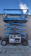 Blue Genie GS3369 RT scissor lift with the platform raised about halfway, scissor arms extended, side view