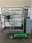 Green and silver Genie GR-20 Runabout vertical mast lift, lowered, side view with platform extension out