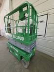 Green Genie GS-1930 scissor lift, stowed, front 3/4 view with platform controls on the rail